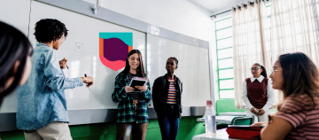 Students presenting in front of a whiteboard during a classroom activity.